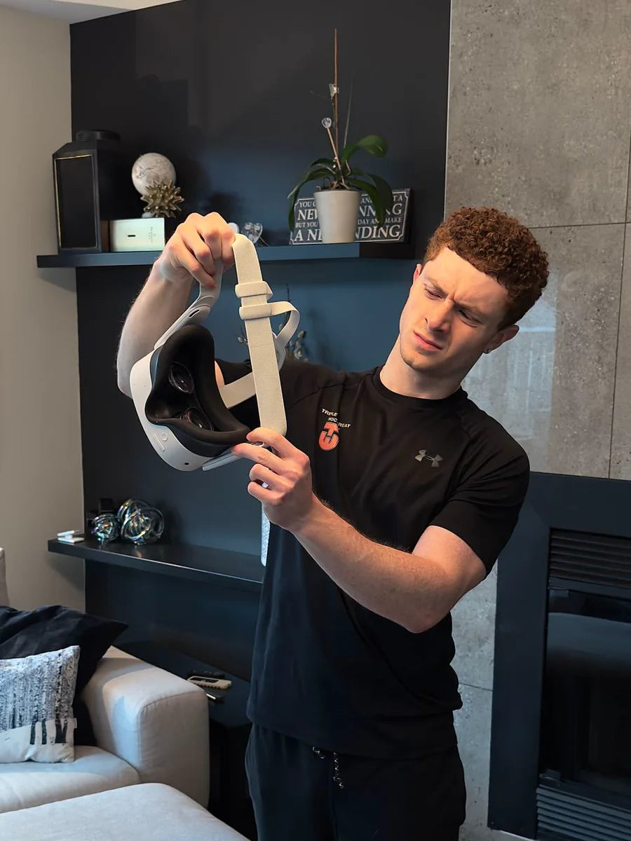 Person inspecting the basic Quest elastic strap before a VR workout